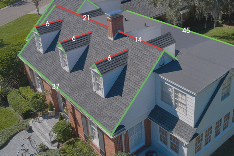 Aerial view of residential roof with measurements outlined