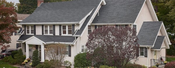 beauty shot of a white home with gray GAF roof