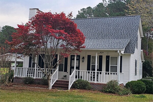 GAF Timberline HDZ shingles installed on a white sided house. 