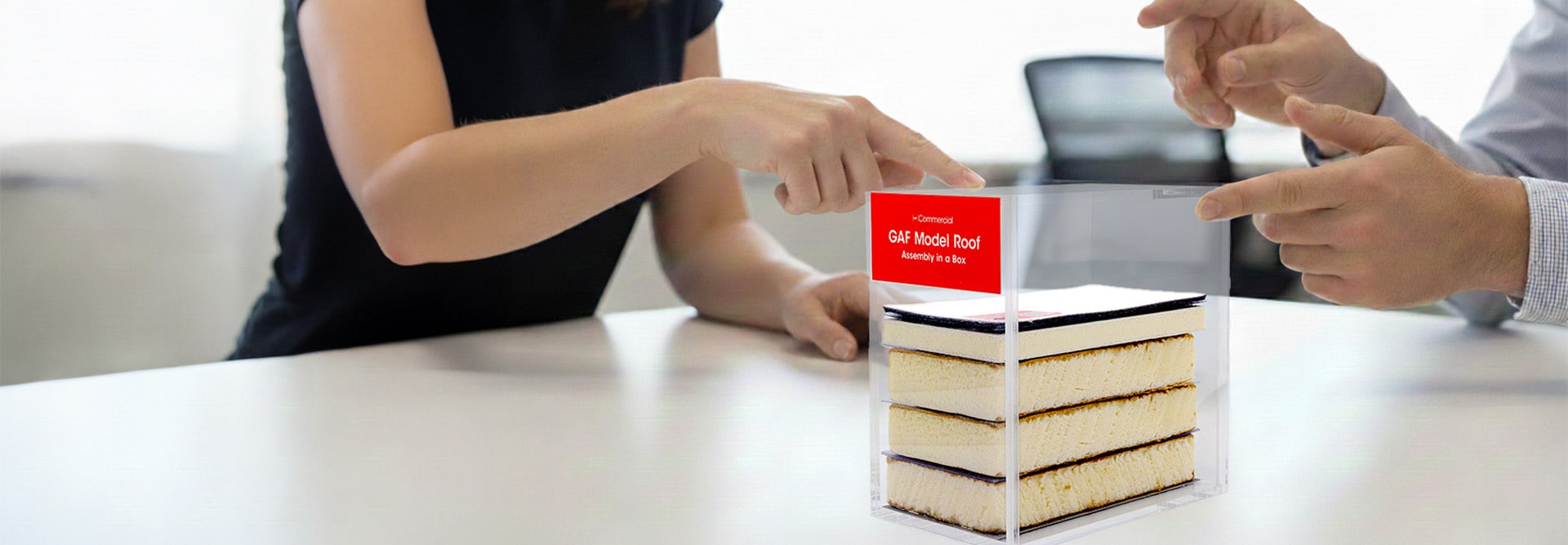 A GAF certified commercial contractor presenting a flat roof assembly using the Model Roof demonstration tool.