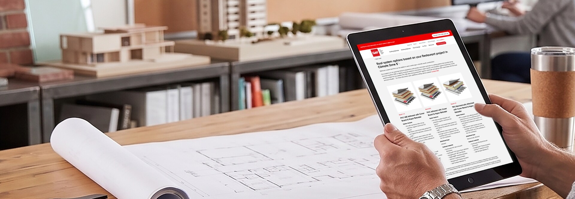 A user reviewing customized commercial roof assembly options on a tablet using the GAF Commercial Roof Selector tool.