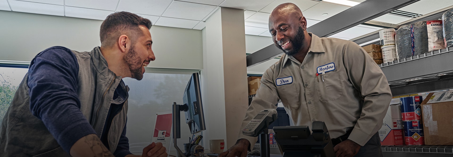 A gaf representative speaking to a roofing supplier about GAF resources to help grow business