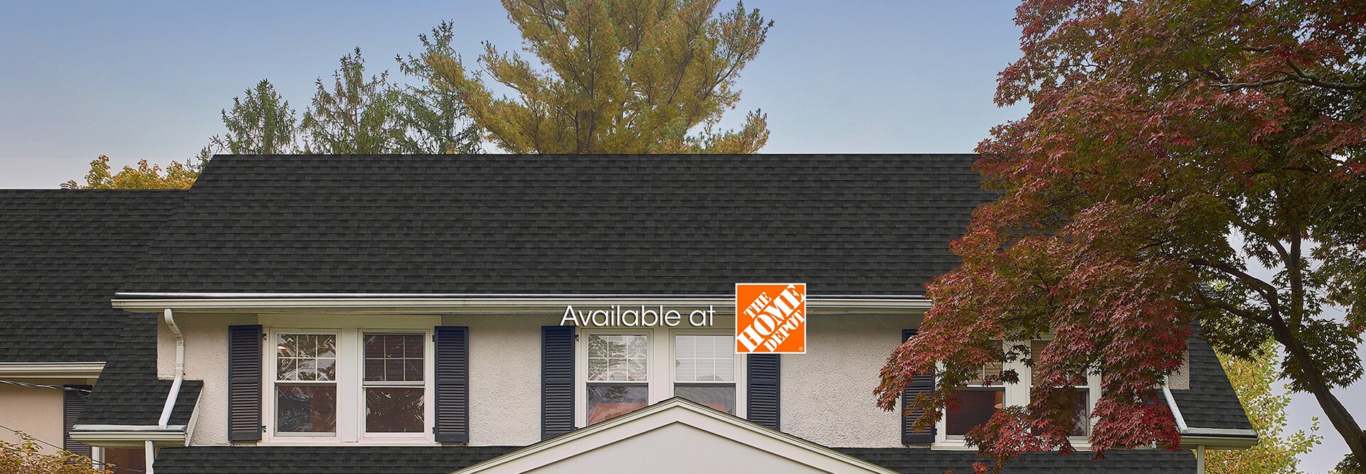Close-up of a white home with black GAF shingles