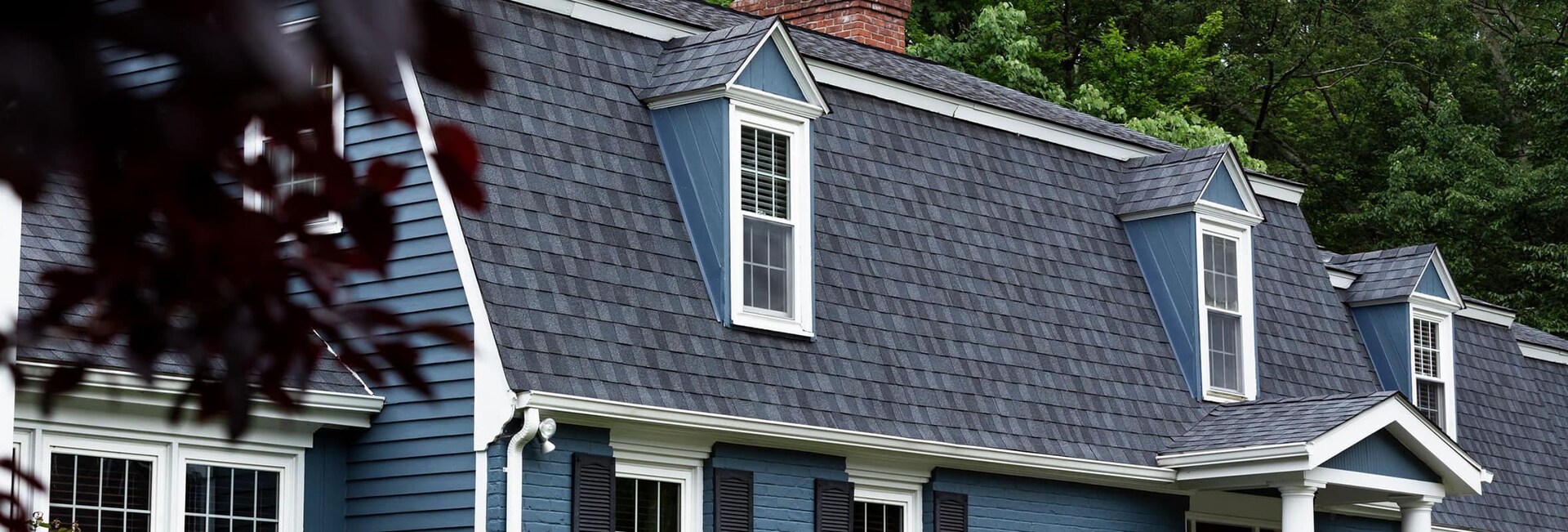 Blue home with fortitude roof shingles completed by Power Home Remodeling