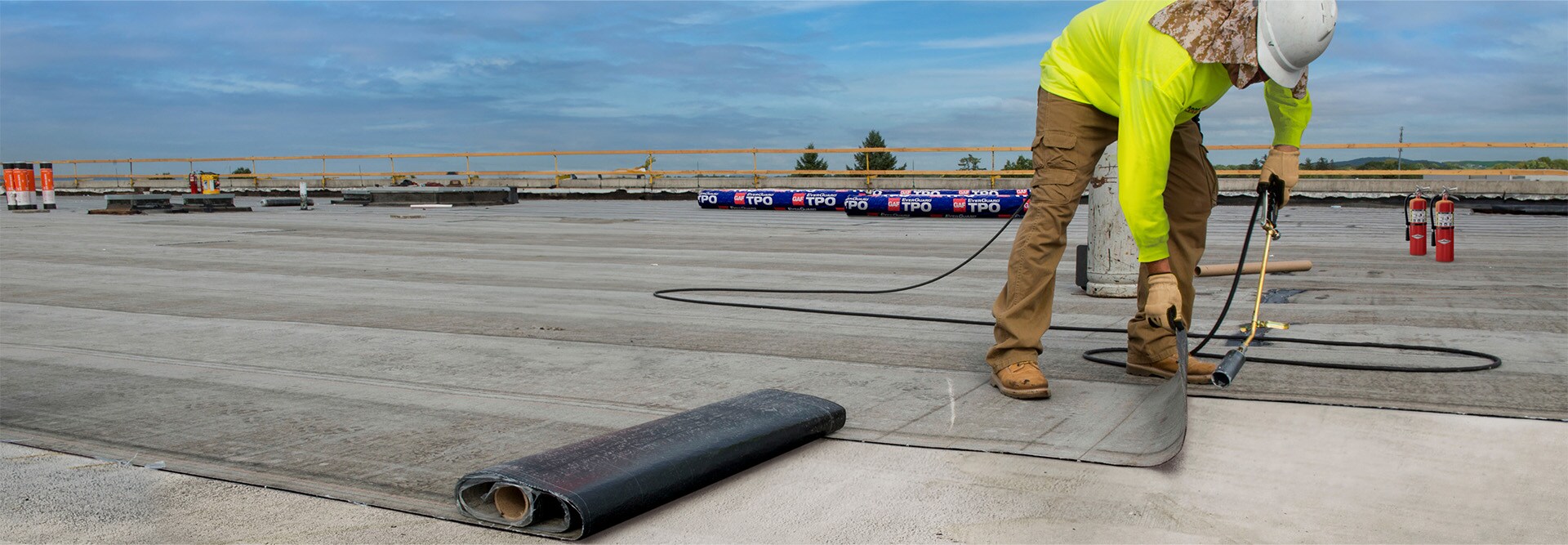 commercial contractor installing EverGuard® TPO Membrane on a flat roof