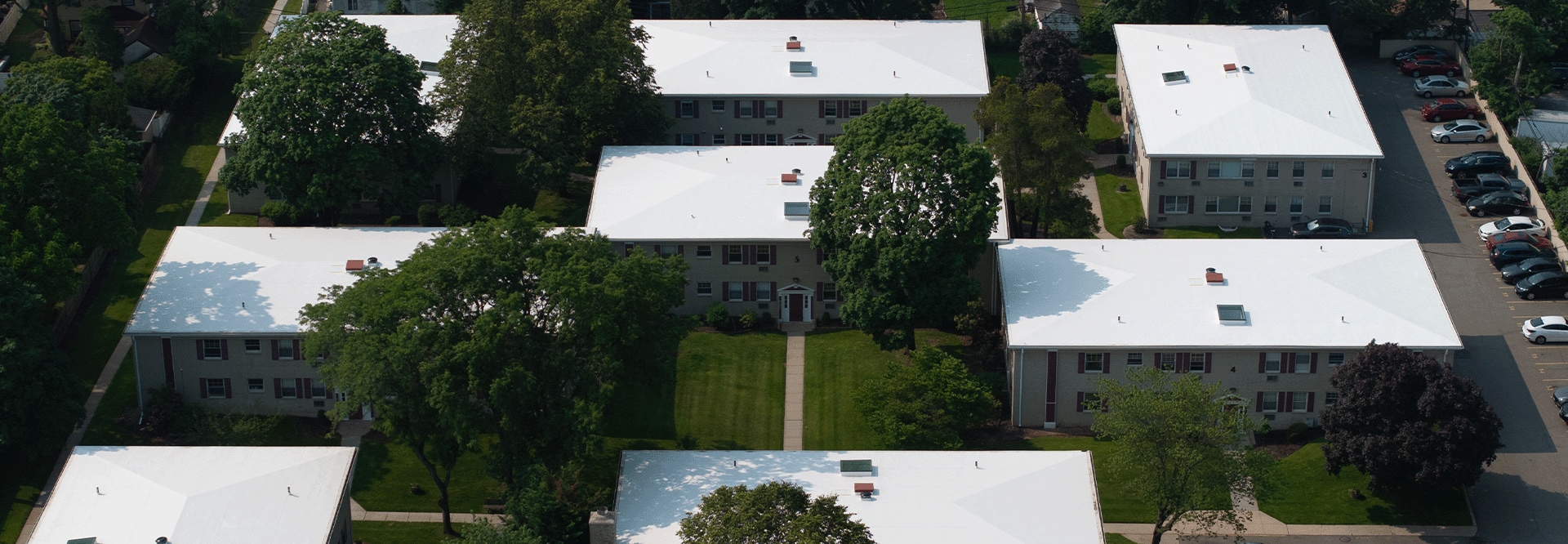 Aerial view of the Post House, a multi-family HOA with 12 buildings, showcasing their newly recovered roofs with GAF materials.