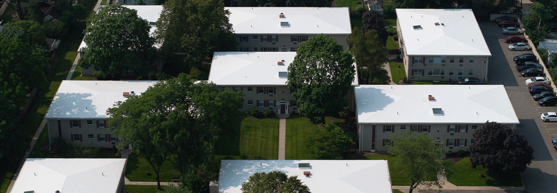 Aerial view of the Post House, a multi-family HOA with 12 buildings, showcasing their newly recovered roofs with GAF materials.