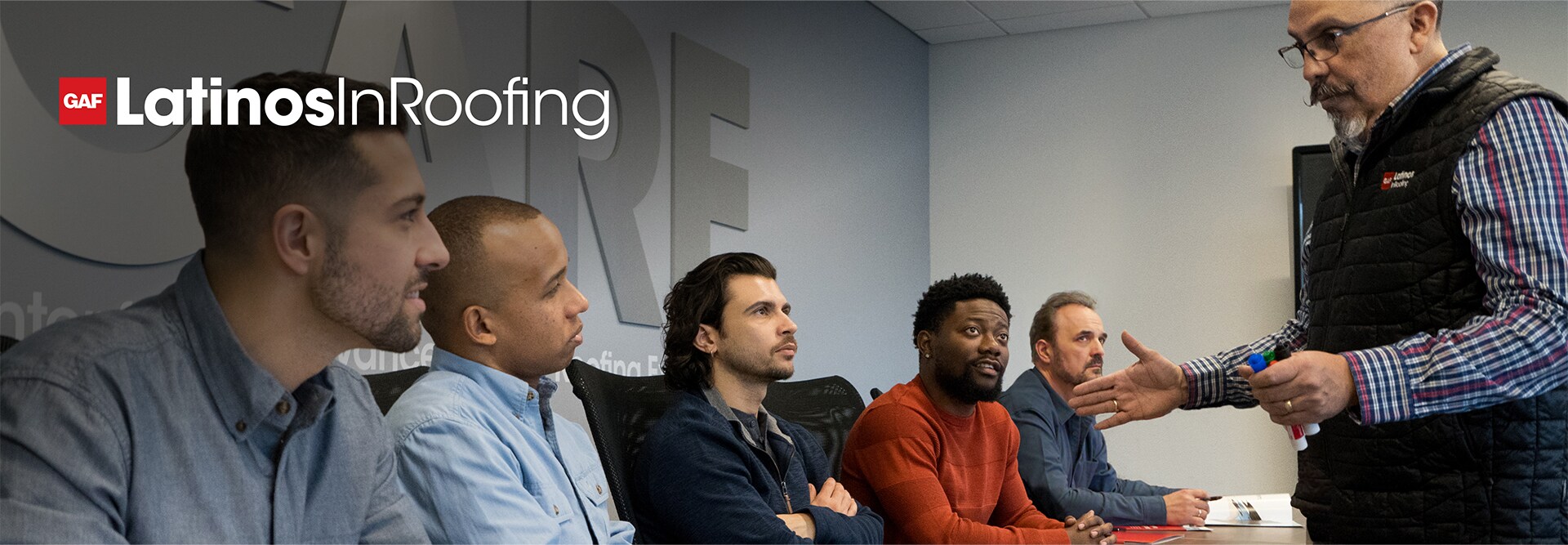 Latino roofing contractors engaging with GAF CARE roofer training center