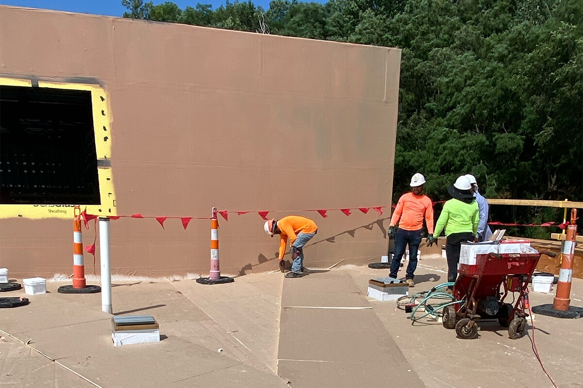 Roofing contractors working on the roof for the Goodwill of the Great Plains headquarters