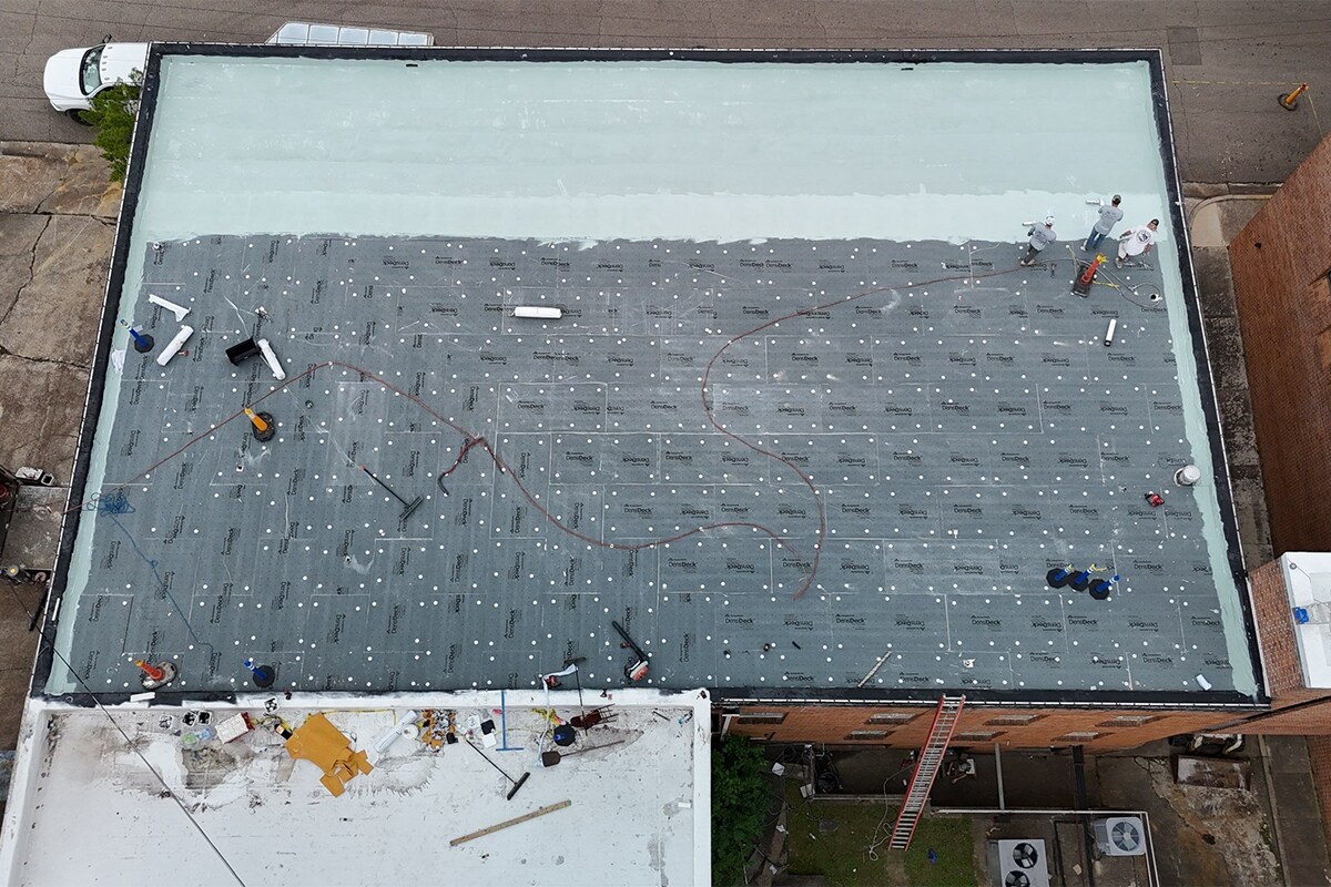 GAF Certified commercial roof contractors applied the layers of the silicone roof system.