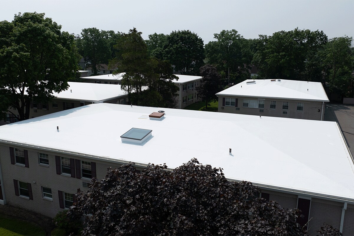 Front view of the roof recovery system installed on the Post House with GAF flat roofing materials.