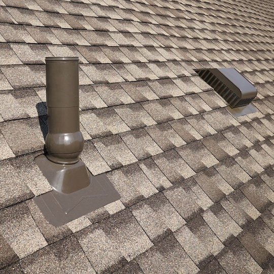 A close-up view of an asphalt shingle roof featuring GAF roof accessories that can help reduce water penetration.