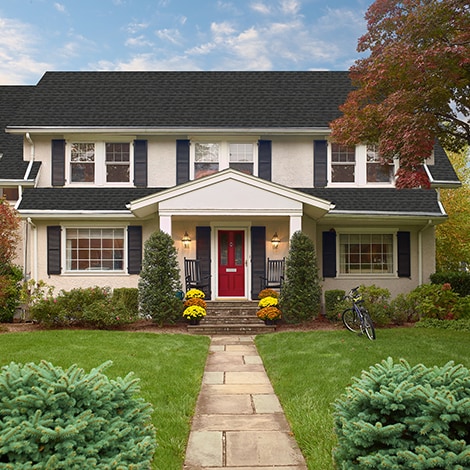 A house featuring GAF-manufactured Charcoal shingles on its roof.