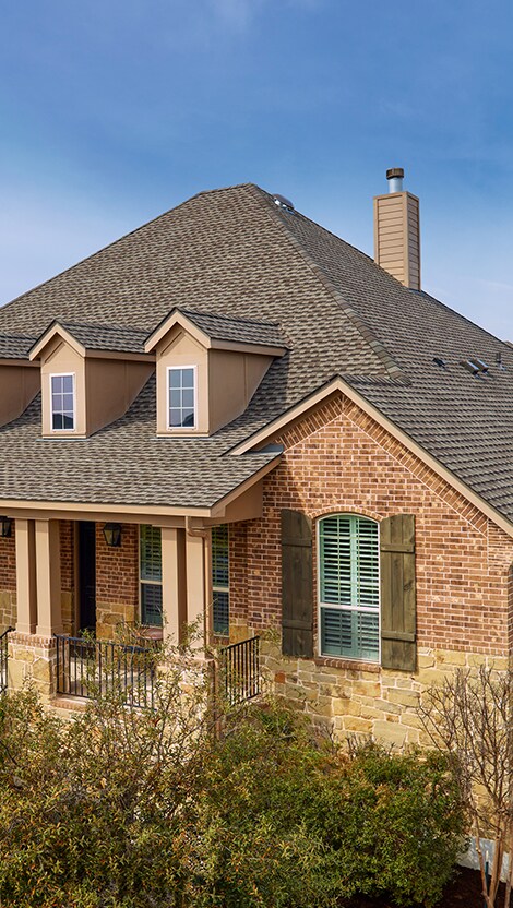 Bird’s eye view of a house with Weathered Wood roofing shingles manufactured by GAF.