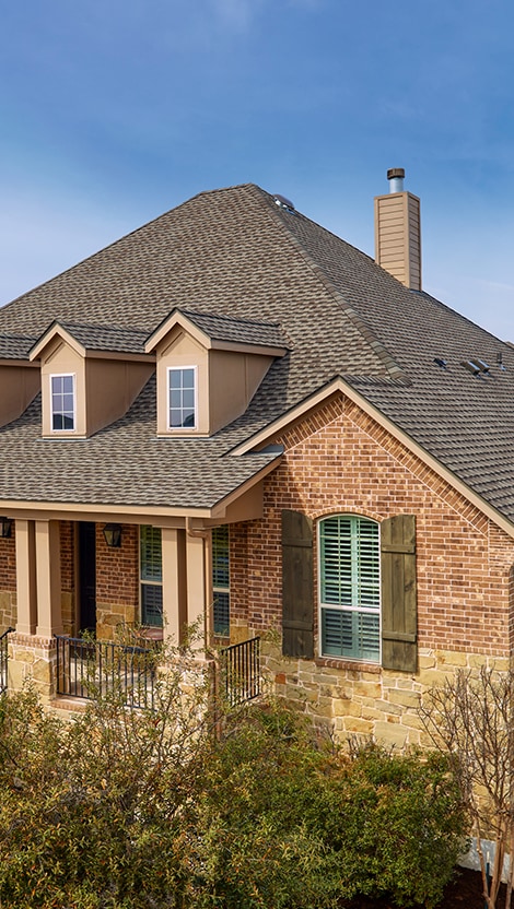 Bird’s eye view of a house with Weathered Wood roofing shingles manufactured by GAF.