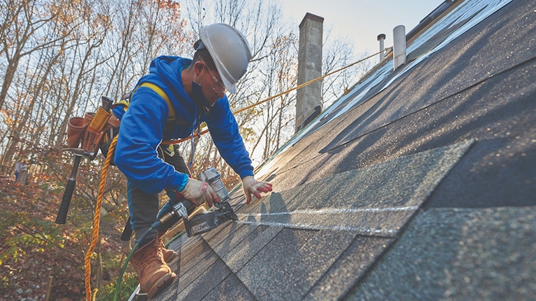 Contractor attaching GAF hail resistant shingles