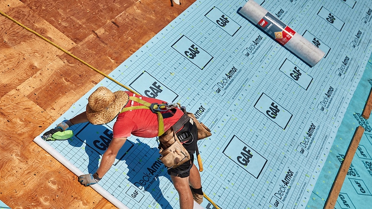 Contractor sealing the roof deck on a GAF Fortified roof