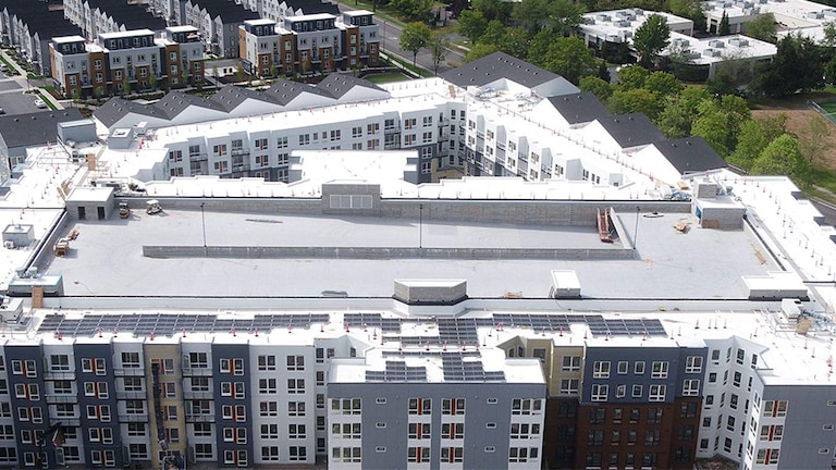 Arial view of the Avalon Bothell Commons building which features both steep-slope and low-slope roof designs