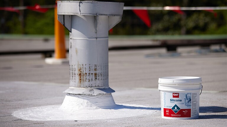 Bucket of GAF Silicone Mastic Flashing.