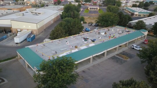Arial shot of a mod-bit recover project on a commercial roof.