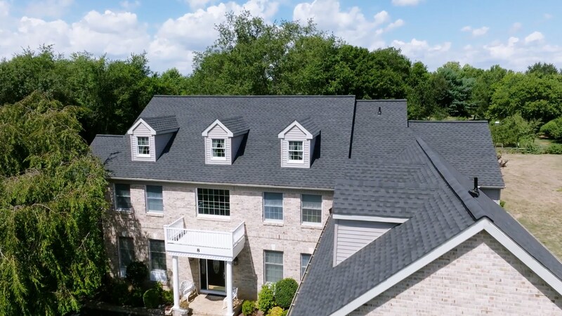 Aerial view of a house featuring a roof made with Timberline ASII shingles by GAF.