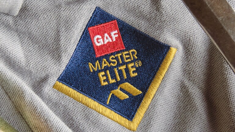 A roofing company’s representative talking to homeowners in their living room about an upcoming project.