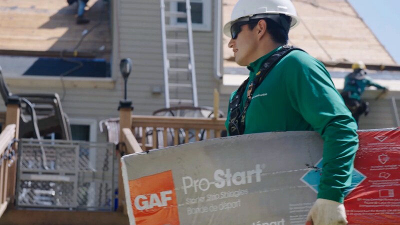 Roofer carrying a package of GAF Pro-Start