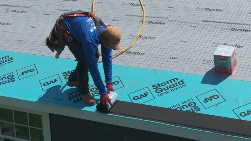 Roofer installing GAF QuickStart on a residential roof