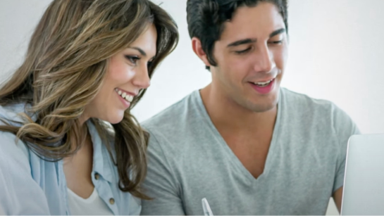 Homeowners reviewing GAF warranty options